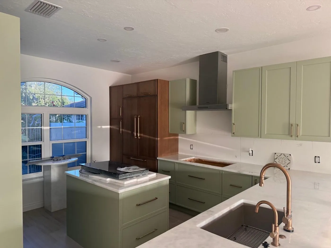 Modern sage green kitchen cabinets with quartz countertops by Life Decor
