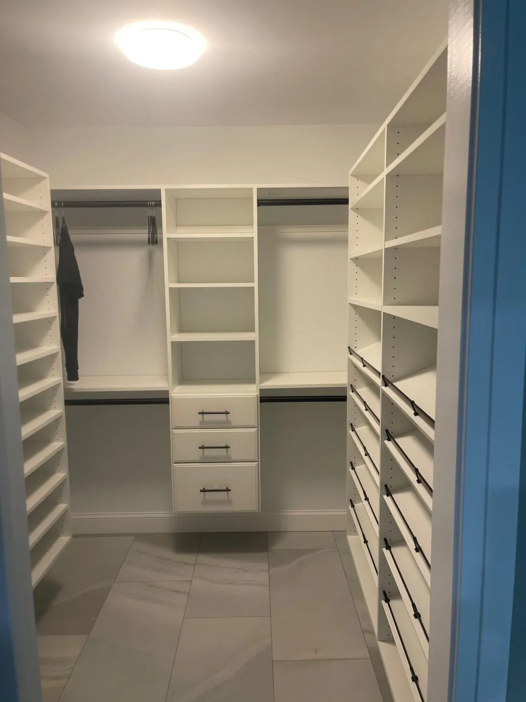 Custom walk-in closet cabinetry with built-in shelving in a Sarasota home