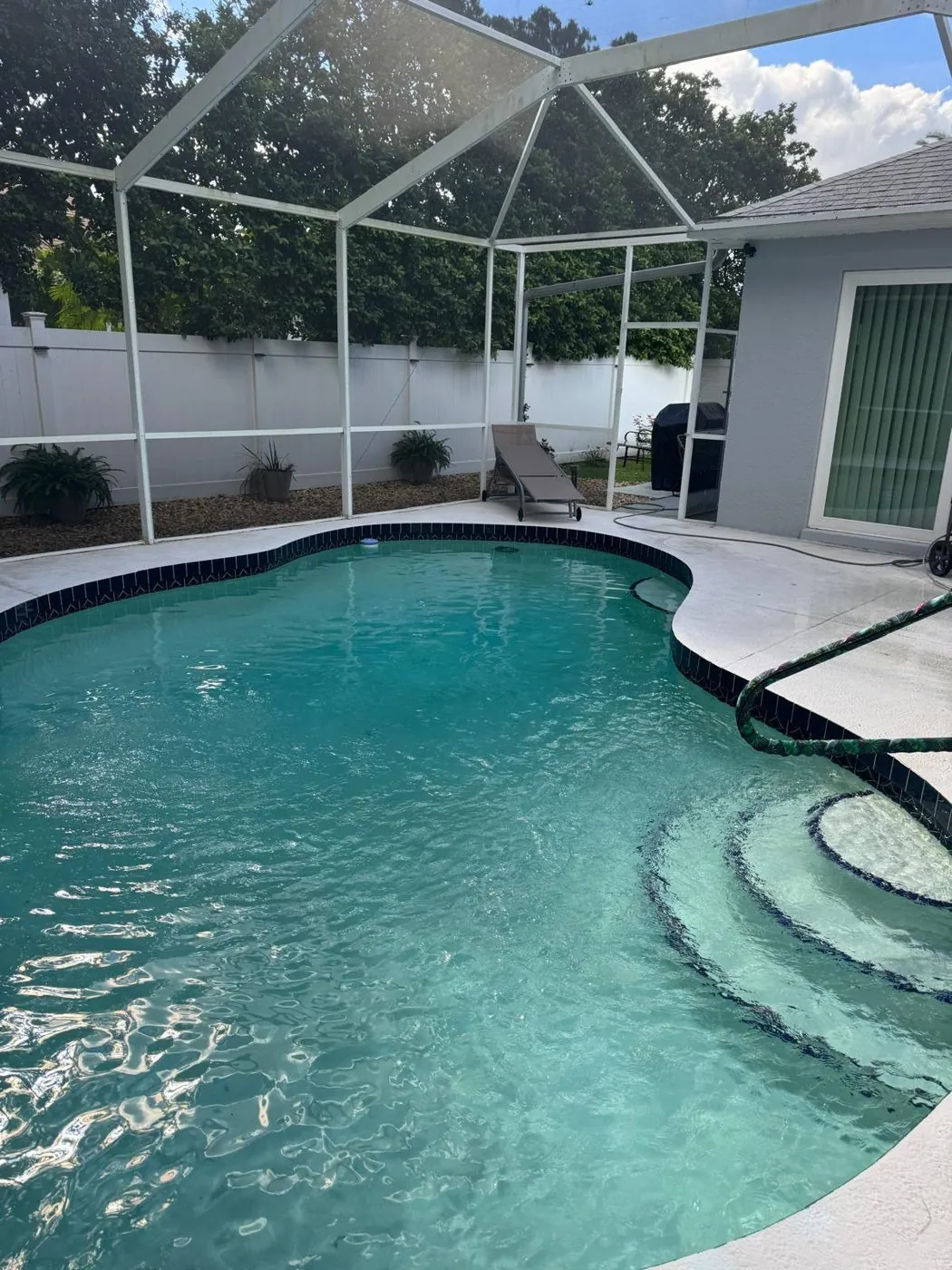 Sealed paver pool deck inside a screened Sarasota lanai