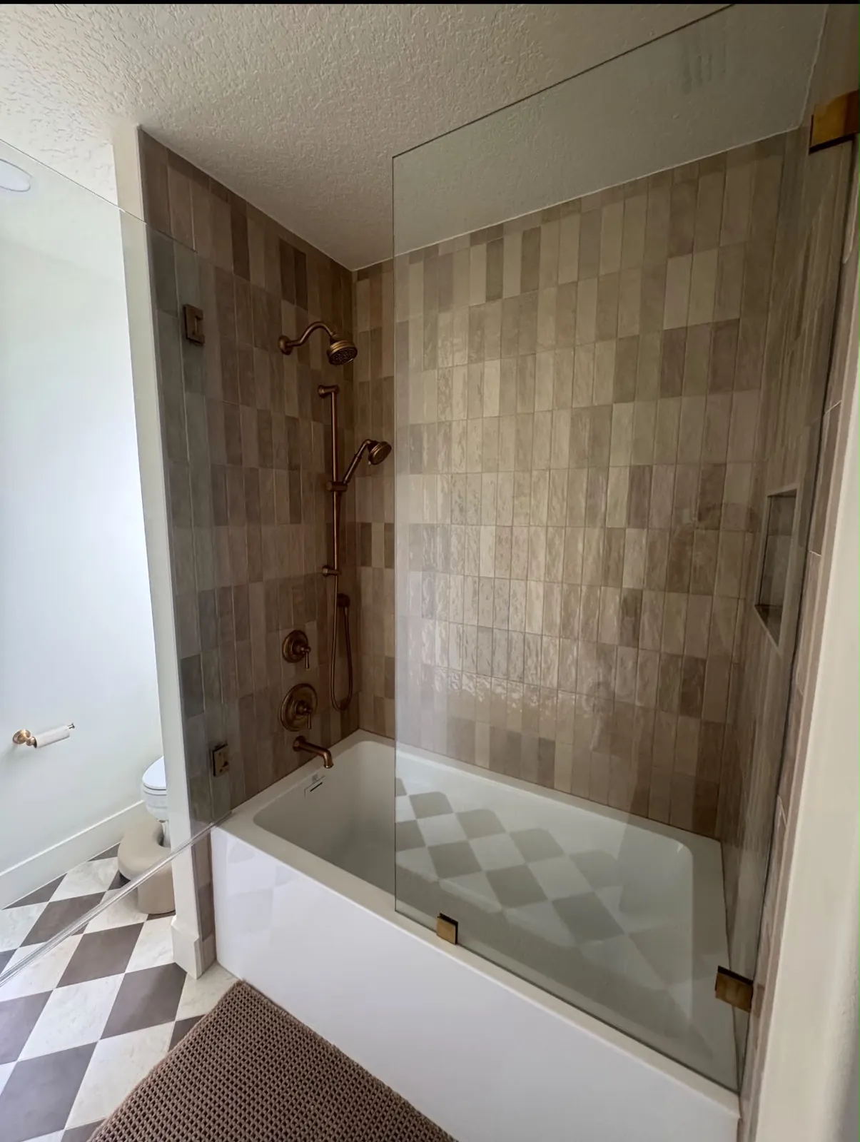Bathroom remodel with tiled tub and shower and frameless glass panel in Sarasota County