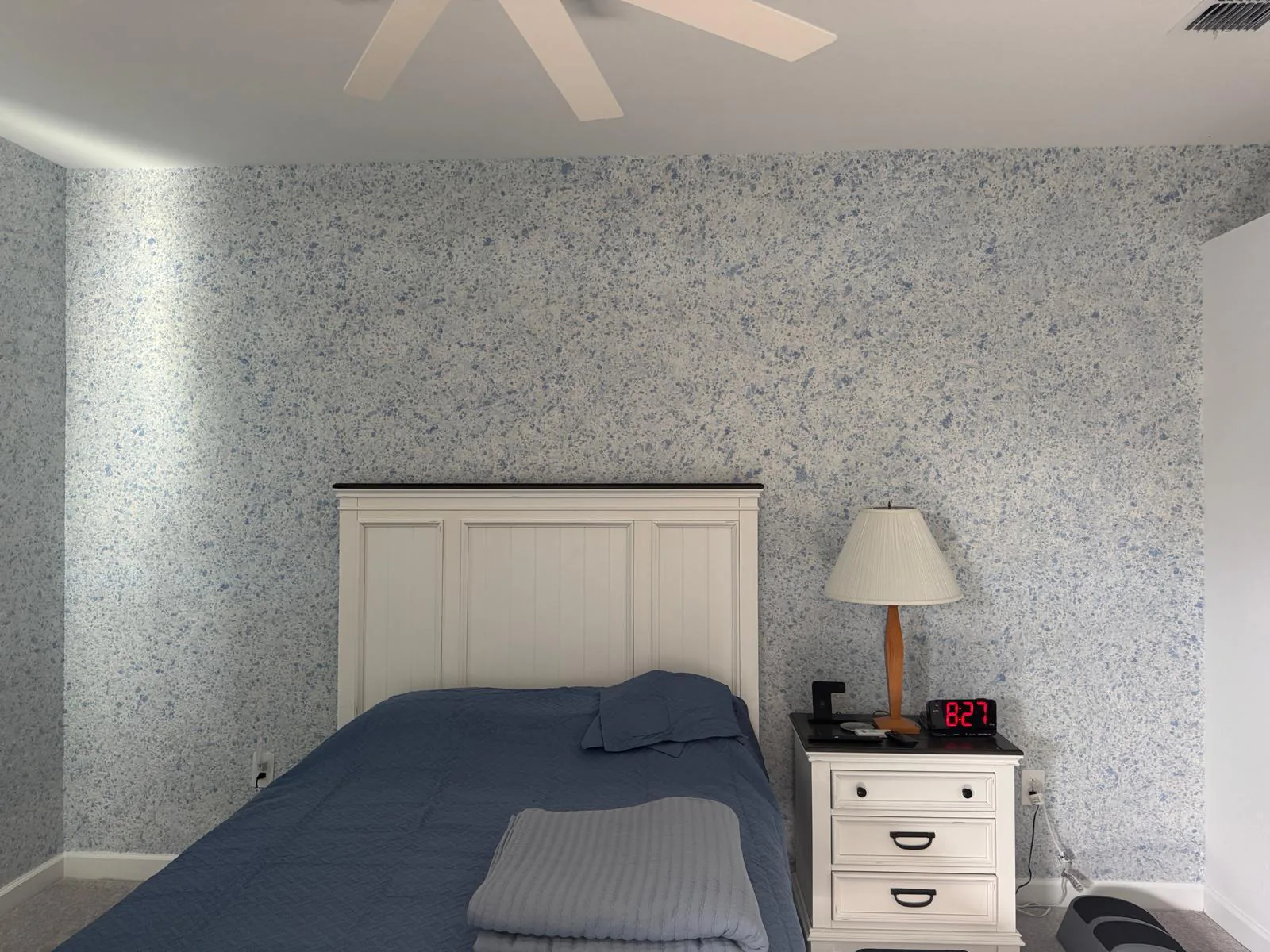 Bedroom corner finished wall to wall in cream and slate blue flecked liquid wallpaper in Lakewood Ranch, FL