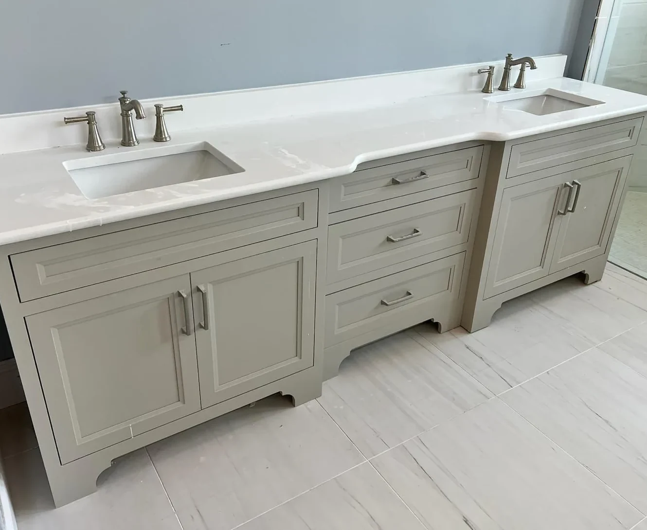 Long custom double vanity in greige cabinets with white quartz top and undermount sinks in Lakewood Ranch, FL
