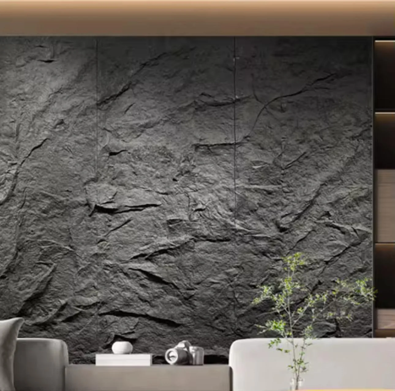 Full-height black rock-textured PU stone panel wall behind a light sofa and low console in Sarasota, FL